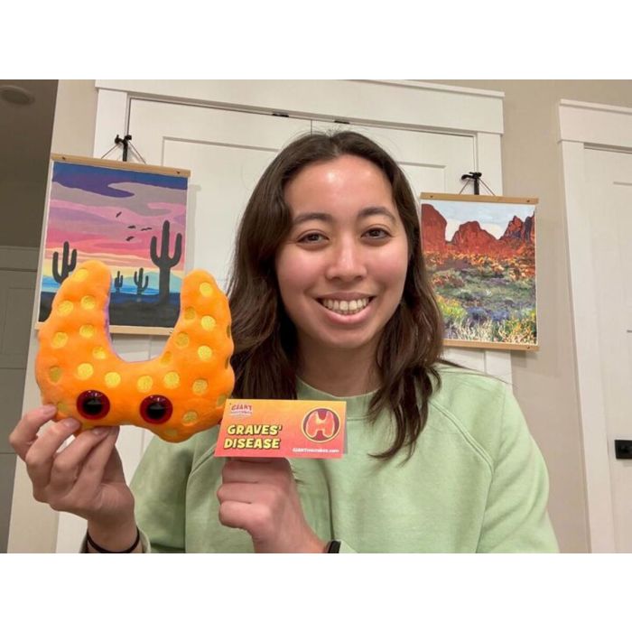 Model holding Graves plush