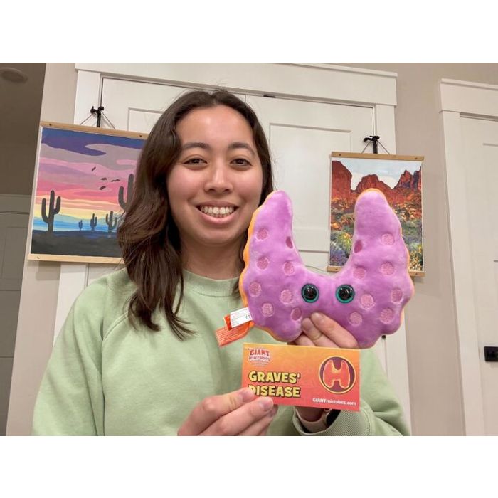 Model holding Graves plush reverse