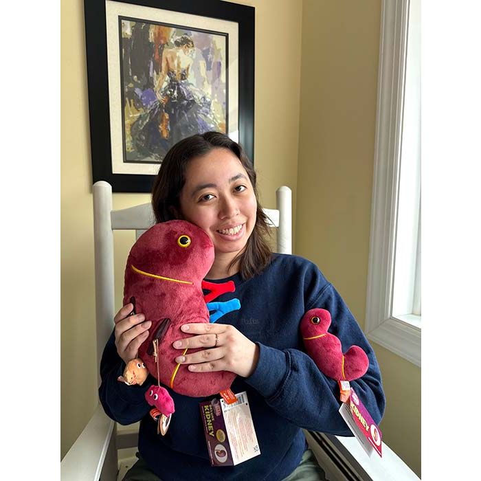 Model holding Deluxe Kidney with minis