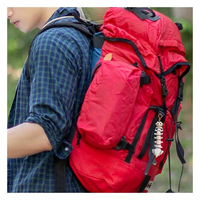 Man with spine key chain on backpack