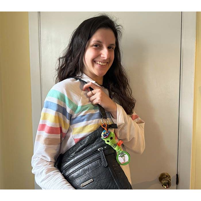 Model with THC key chain on bag