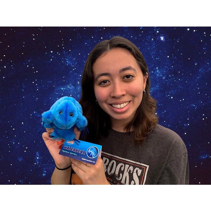 Waterbear plush in space with woman